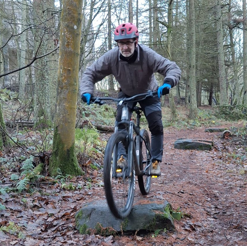 Joe going over a jump on his bike.